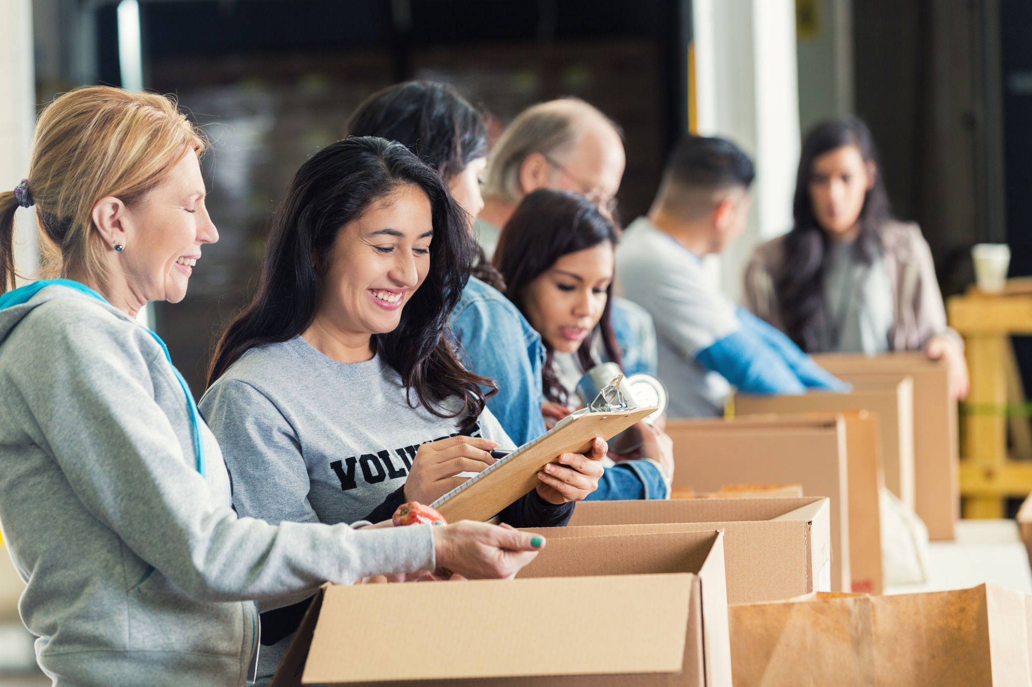Volunteers in a Charity filling Cardboard Boxes